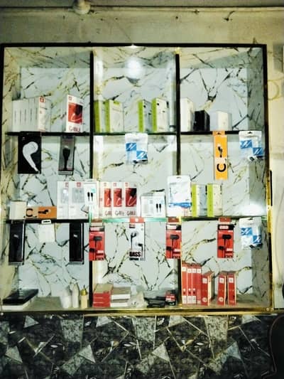 counter rack or mobile shop ka kuch Saman hy.