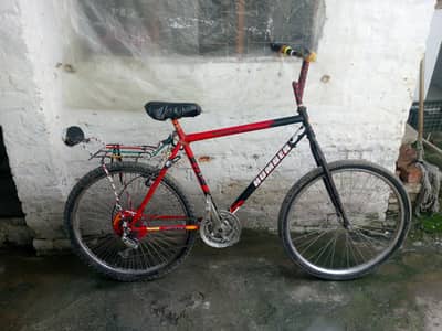 A bicycle full size with gears and smooth bicycle