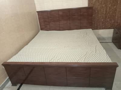 bed with dressing and side tables