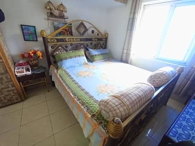 king size iron bed in golden and chocolate colour with 2 side tables