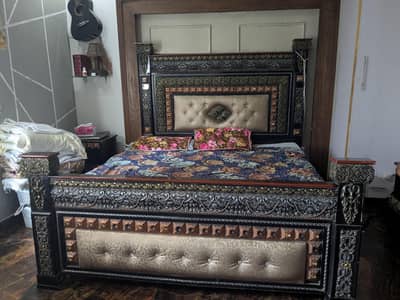 wooden bed with dressing and side      table