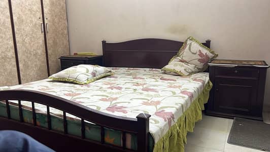 One bed one side table and two chairs