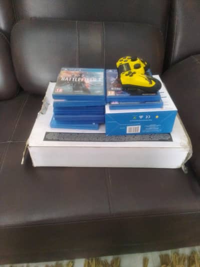 PS4 WITH 4 CONTROLLERS AND 3 GAMES PRE-INSTALLED AND 9 PHYSICAL