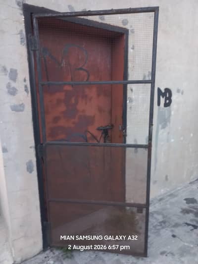 Heavy angle metal frames with metal net and pipes metal and door frame