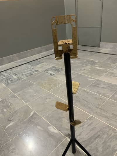 Metal stand with black and golden colour