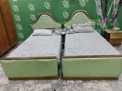 Single beds with side table