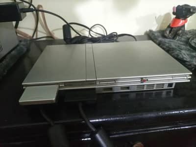 PS2 (slim) with 2 wired controllers and 8mb memory card