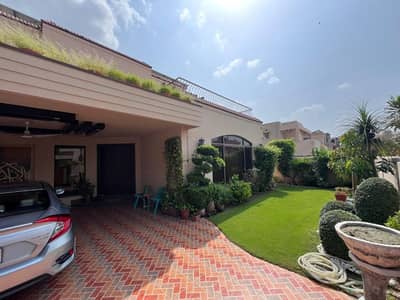 SPANISH DESIGN 1-KANAL ELEGANT AND FULLY MAINTAINED SUPER HOT LOCATED BUNGALOW IS AVAILABLE IN THE BEST BLOCK OF DHA LAHORE.