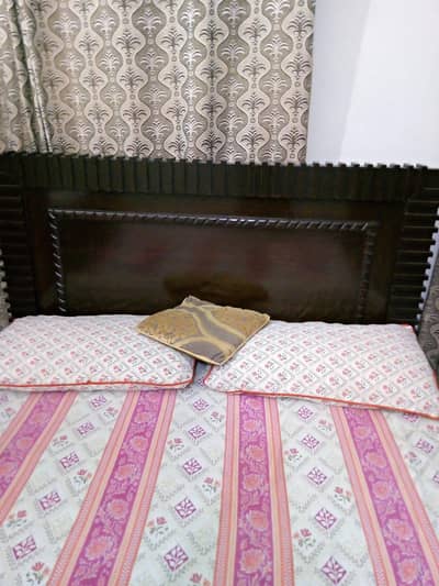 Queen bed with spring mattress.