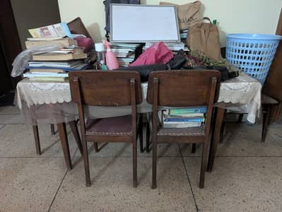 Wooden Dining Table with Lace Tablecloth and Clutter