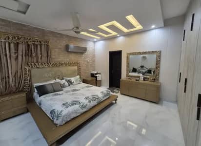 golden bed with 2 side tables and dressing table with mirror