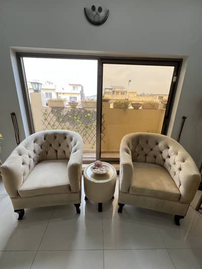 2 single seater comfortable sofa set with table.