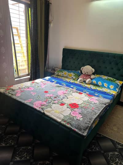 bed and 1 side table without mattress
