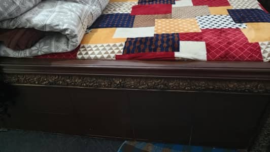 wooden bed with side table and dressing