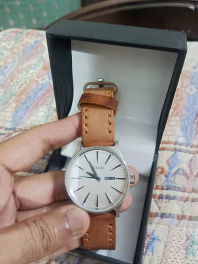Nixon Sentry Leather White Sunray Saddle watch.