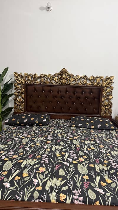 Luxury carved wooden 6 by 6 bed, two side tables and dresser.