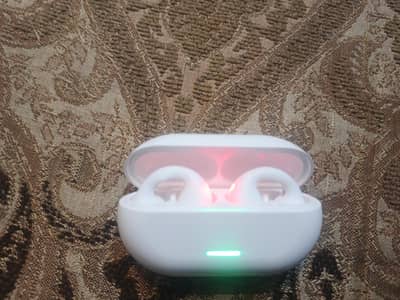 white open -ear Bluetooth earbuds with charging case