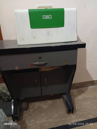 brother sewing machine with table cabinet  2 years use perfect