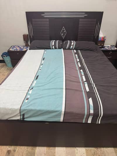 Queen size bed with side tables and spring mattress