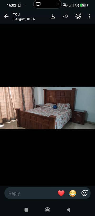 King bed with side tables and dressing table.