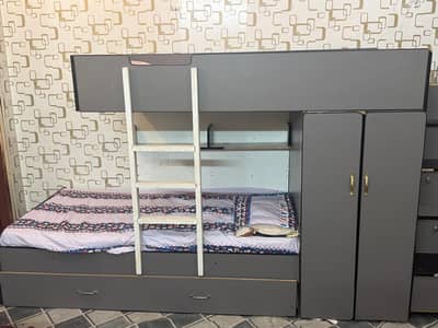 Kids wooden bunk bed with built-in cupboard & drawers.