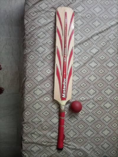 Cricket bat with rubber cock ball