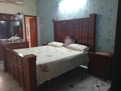 King bed with side tables and dressing table.