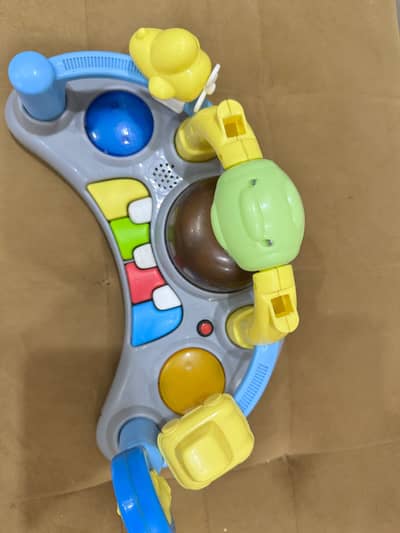 Baby walker with music, toy panel and sun canopy — used like new