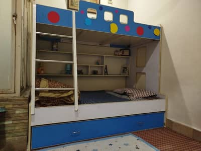 Triple bunk bed with two mattress and double door cupboard
