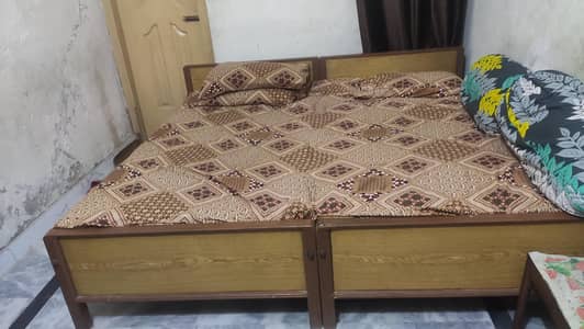 2 single wooden beds