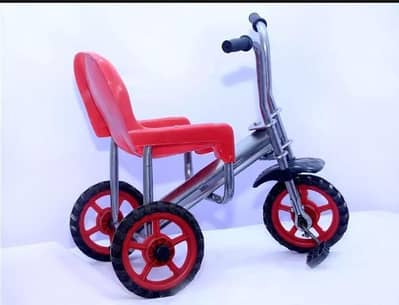 red plastic kids tricycle with red wheels