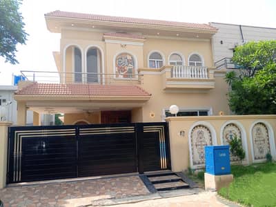 10 Marla Luxury House in DHA 4 Bedrooms, 5 Baths, Modern Interior & Landscaped Courtyard
