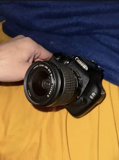 Canon D1200 with charger and hanging strap and charger