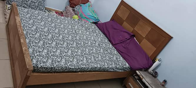 two wooden beds with mattresses