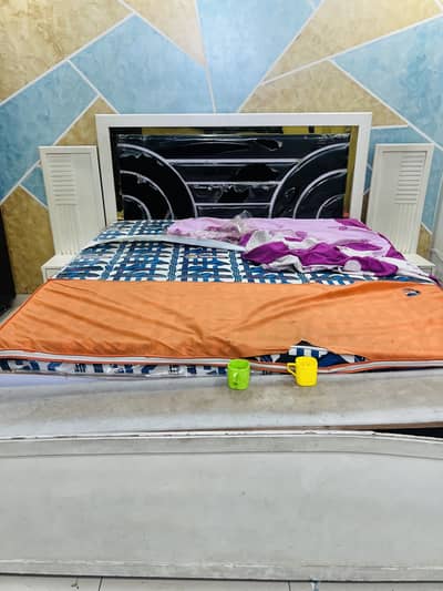bed without mattress with side table
