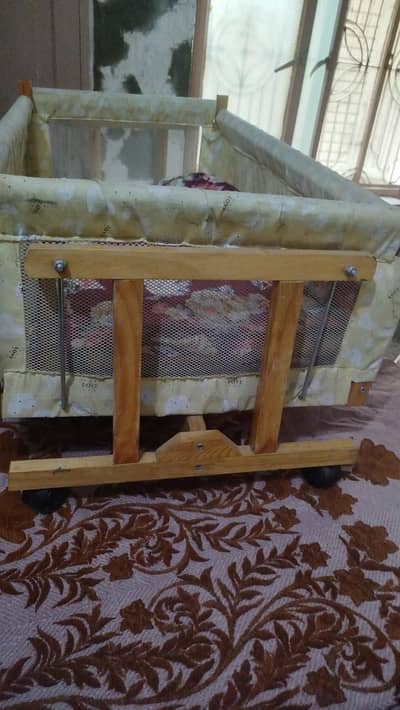 wooden cot and wooden swing