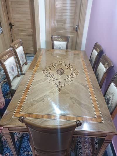 8 person's dinning table and it's chairs made of pure walnut wood .
