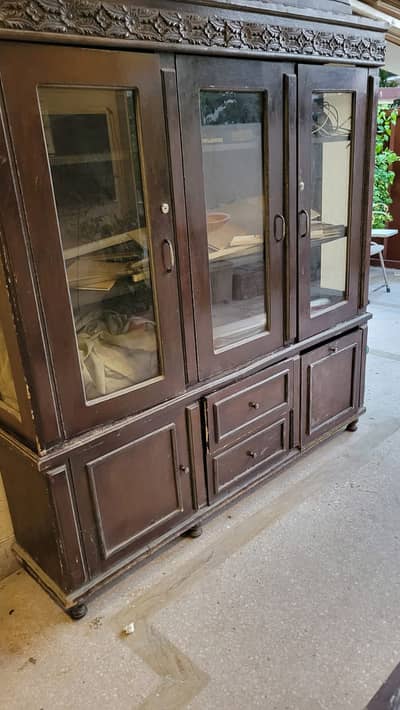 heavy wooden cabinet with three doors