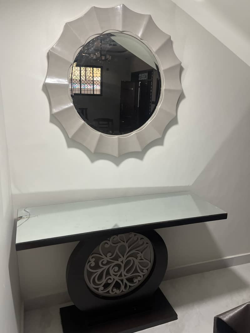 Console table with a mirror available 0