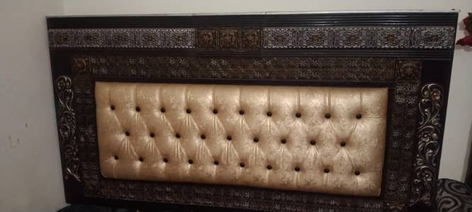 bed with one side table and dressing table