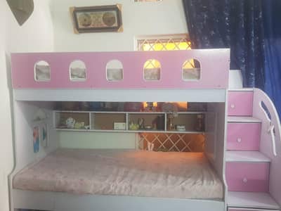 Double-Story bed for children with wardrobes and shelves.