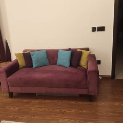 2 seater sofa with 6 multi colored cushions for sale