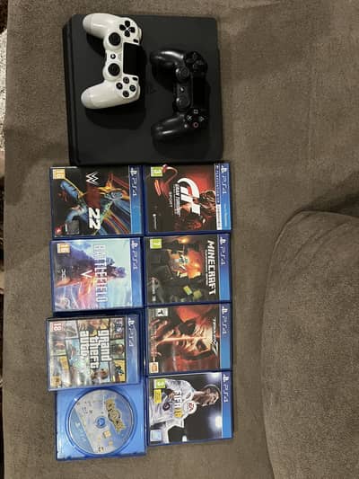 SEALED PS4 SLIM 500GB WITH 2 CONTROLLERS AND 8 PS4 GAMES