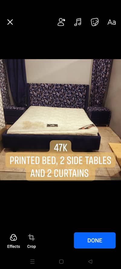 Printed Blue color bed with side tables and curtains.