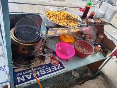 Street Food Fries stall with Fresh Potato Fries and Seasonings Tags: