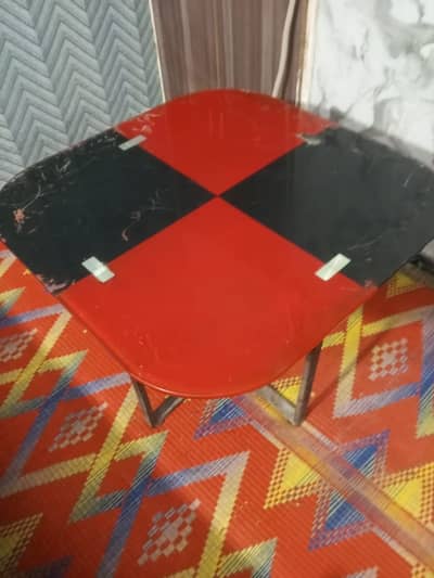 Glass top table with metal base