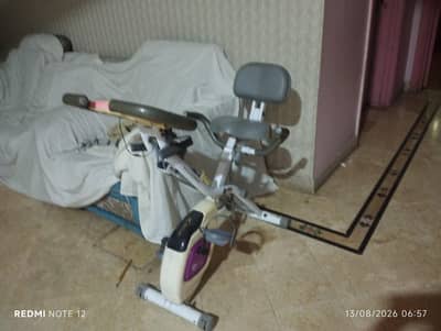 exercise cycling machine with hand gripper and phone holder