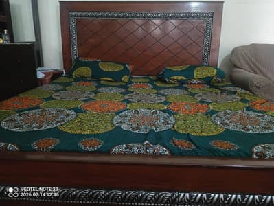 wooden bed with mattress