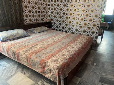 wooden double bed with mattress