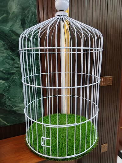 White cage with green grass mat. .